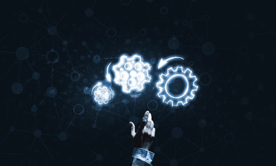 Glowing cogwheel mechanism icon on dark background as symbol of teamwork