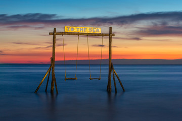 Wooden swing on the beach of Koh Kood island in Thailand.