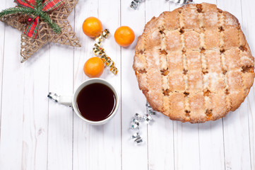 Traditional apple pie and black tea with decoration for Christmas