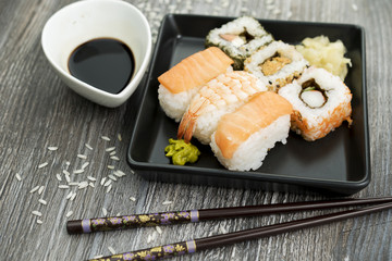 Set of sushi and chopsticks, traditional asian dishes.
