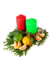 Red and green candles, mandarin and lime. Christmas composition. Isolate on a white background