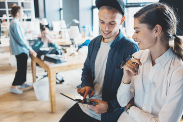 Work team discussion. Man and woman talking about new social and digital plans. Big bright loft office