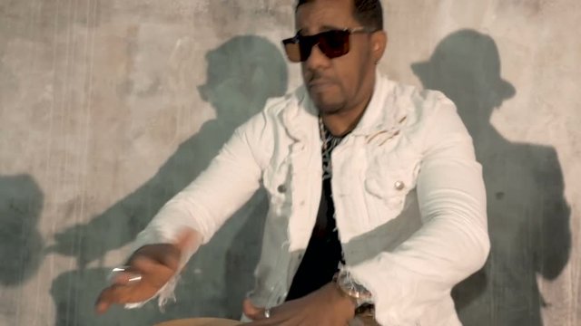African male musician playing drums. Very emotional. Close-up.