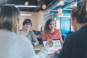 Meeting room concept. Marketing business discussion in cozy open space office. Four people