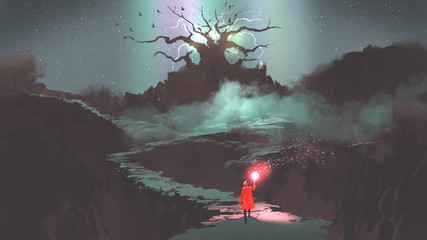 Fototapeta premium dziewczyna w czerwonym kapturze z magiczną pochodnią chodzącą po górskiej ścieżce prowadzącej do drzewa fantazji, cyfrowego stylu sztuki, malarstwa ilustracyjnego