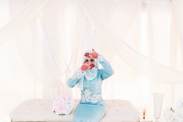 Fototapeta na wymiar Portrait of beautiful woman showing her hennaed hands with wedding dress.