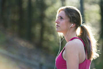 Fresh, attractive young fitness woman in sports clothes on nature trail.