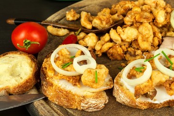 Heap of domestic salty fried pork greaves. Fatty junk food. Pork greaves on the kitchen board.