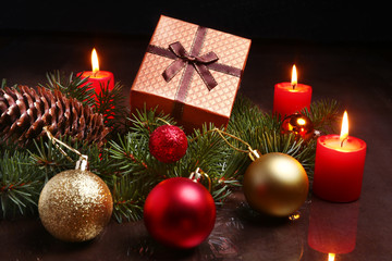 christmas decoration with gift boxes, red candles, christmas tree and colorful balls. Selective focus.