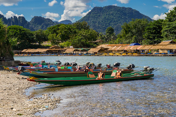 long tail boats on sunset at Song river, Vang Vieng, Laos.