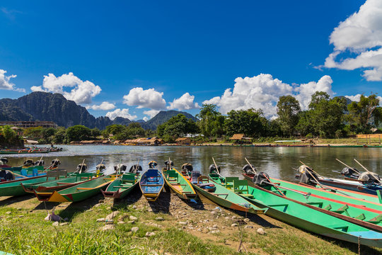 long tail boats on sunset at Song river, Vang Vieng, Laos.