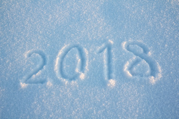 New years sign 2018, handwritten on fresh snow, greeting card design template