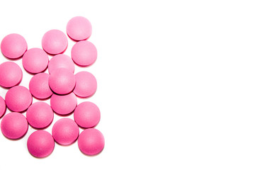 pink medical pills on white background