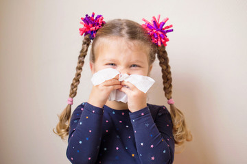The little girl with runny nose blows into handkerchief. © Vitalinka