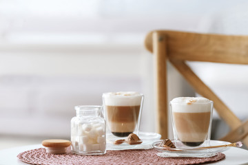 Obraz na płótnie Canvas Glasses with latte macchiato on table indoors