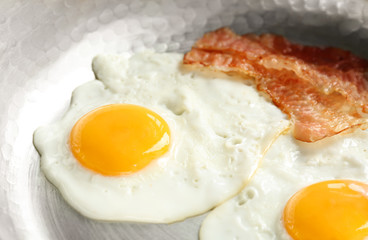 Frying pan with eggs and bacon, closeup
