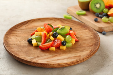 Dish of fresh fruit salad on table