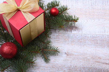 Christmas decoration fir tree with gift box and many balls, on wooden board