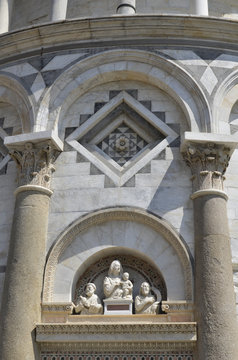 The leaning tower of Pisa. Entrance sculptures detailed.