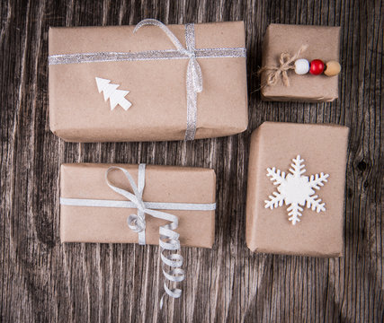Gift boxes package decorated for Christmas or New Year on rustic wooden background