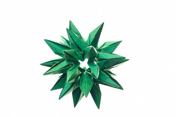 Spiky stellated modular origami art. Made of green paper, folded paper units. Cosmic body, crystal concept. - obrazy, fototapety, plakaty