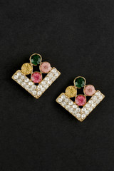 gold rhombuses earrings with gem stones isolated on black