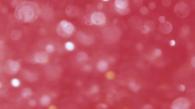 Abstract sparkles or glitter lights. Defocused circles bokeh or particles , pink tone