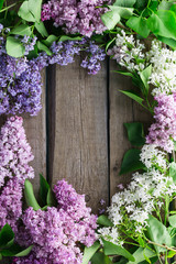 lilac branches on a wooden background