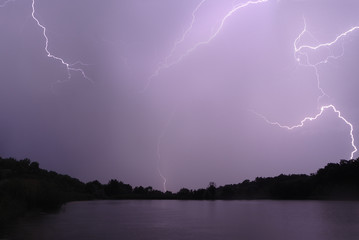 Naklejka na ściany i meble Lightning at the night lake