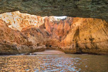 Scenic golden cliffs near Benagil, Lagoa, Algarve. View from a boat on the ocean