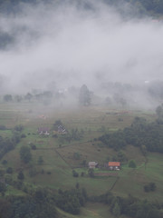 Fototapeta na wymiar Fog at the village in the carpatian mountains