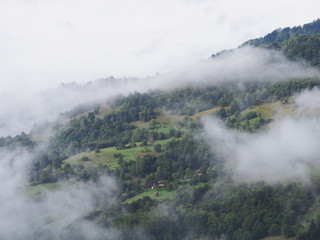 Fog at the village in the carpatian mountains