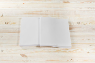 Mockup of magazine, poster, A4 brochure, catalog or flyer isolated on white wooden background. Blank page top view for use in design, mockups and simulations.
