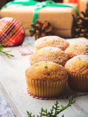 Christmas baking concept - muffins with icing sugar and festive winter decorations