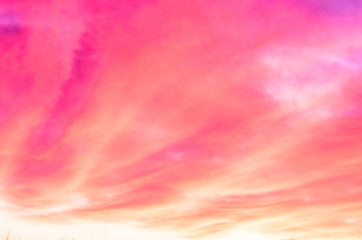 Naklejka na ściany i meble Orange and pink clouds at sunrise