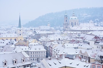 Winter Prague panorama with St. Nicholas church, roofs of Lesser Town and Petrin Hill