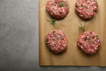  raw minced beef steak burgers on paper