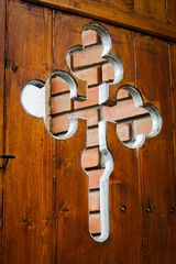 detail of orthodox cross as ornament on church wooden door