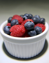 blueberries and raspberries in a bowl