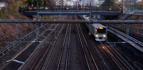 Moving locomotive train and rail tracks in the evening