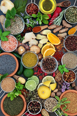 Herb and spice seasoning with fresh and dried herbs and spices with olive oil forming a colourful abstract  background. Top view.