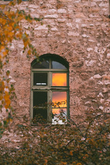 reflection of sunset on old building