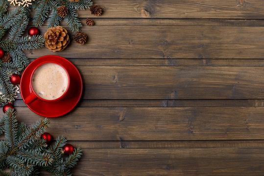 Cappuccino and Christmas decoration on wooden background