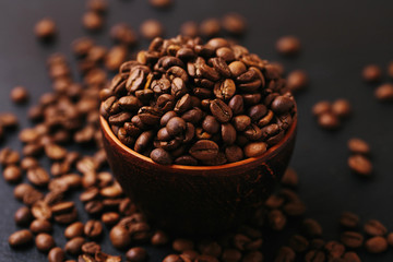 Roasted coffee beans scattered around. Gray background. Horizontal view