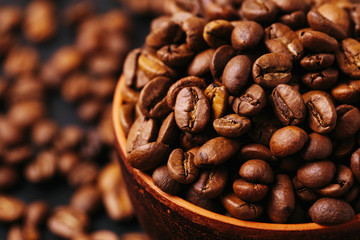 Roasted coffee beans scattered around. Gray background. Horizontal view