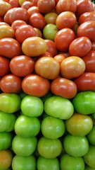 Green and red tomatoes for sale on the market