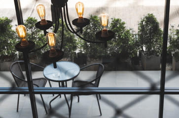 High angle chandelier light interior with table and chair