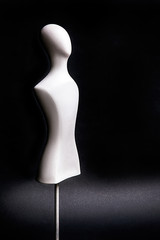White mannequin on the black background.