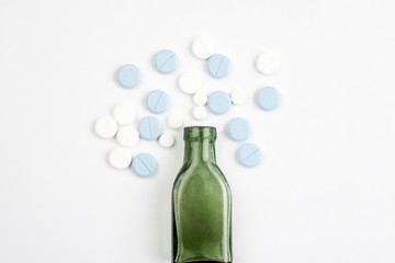 Different medications and pills with vintage pharmacy bottles on a white background