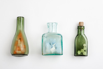 Different medications and pills with vintage pharmacy bottles on a white background